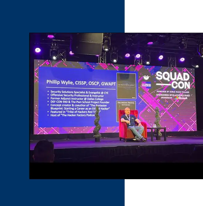 A man sitting on the stage of a convention.